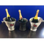 Three Champagne buckets and 3 magnum prop bottles.