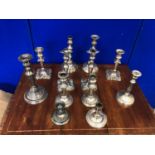 Large collection of antique silver plated candle sticks.