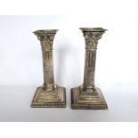 Pair of Corinthian column silver plated candle sticks on square bases H 7''