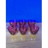 Three large and three small ruby coloured drinking glasses.