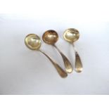 Pair of plain silver plated sauce ladles (initialled P) and another similar.