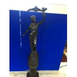 Fine bronze figure of a lady in the Art Nouveau style, holding a torch standing on a matching