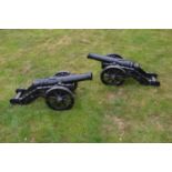 Pair of cast iron cannons on carriages W 140 H 56 D 55