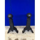 Fine pair of 19th Century cast iron fire dogs in the form of balls sitting on tapering pillars W