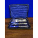 Set of 6 silver handled butter knives with case.