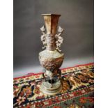 Decorative brass urn on stand.