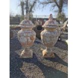Pair of glazed terracotta lidded urns.