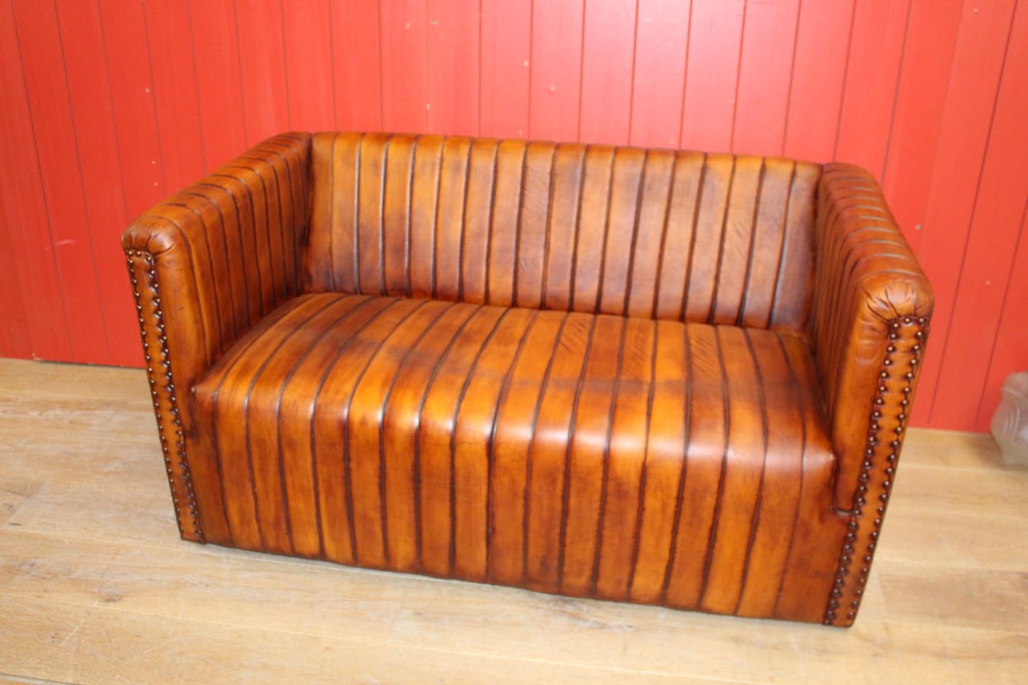 Two seater leather upholstered settee