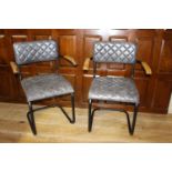 Pair of leather upholstered metal and wood armchairs.