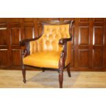 Carved mahogany and leather upholstered armchair
