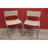 Pair of leather upholstered white metal side chairs