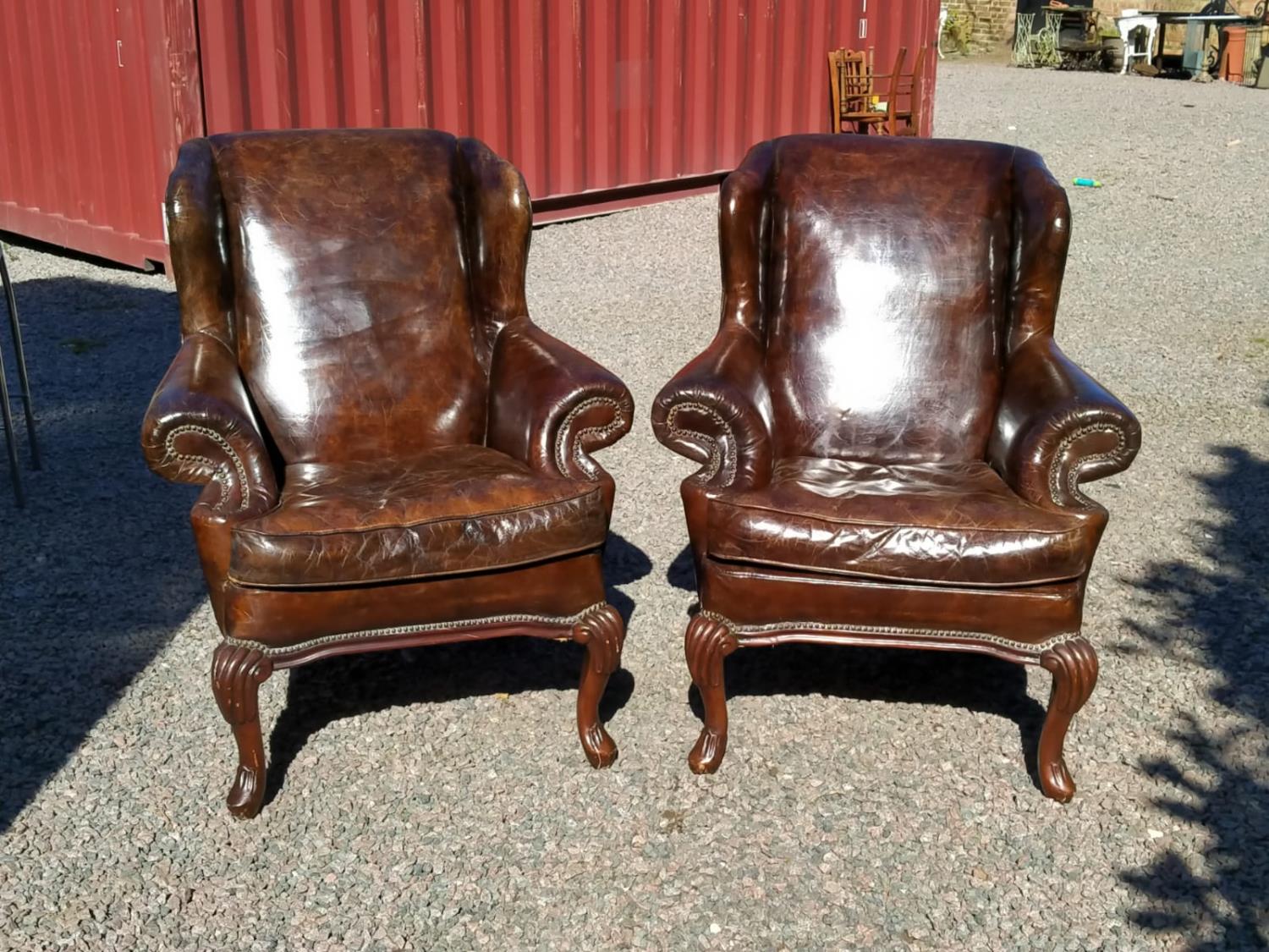 Pair of leather wing back chairs.