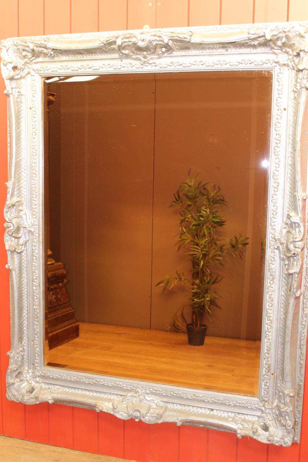 Carved silvered wall mirror