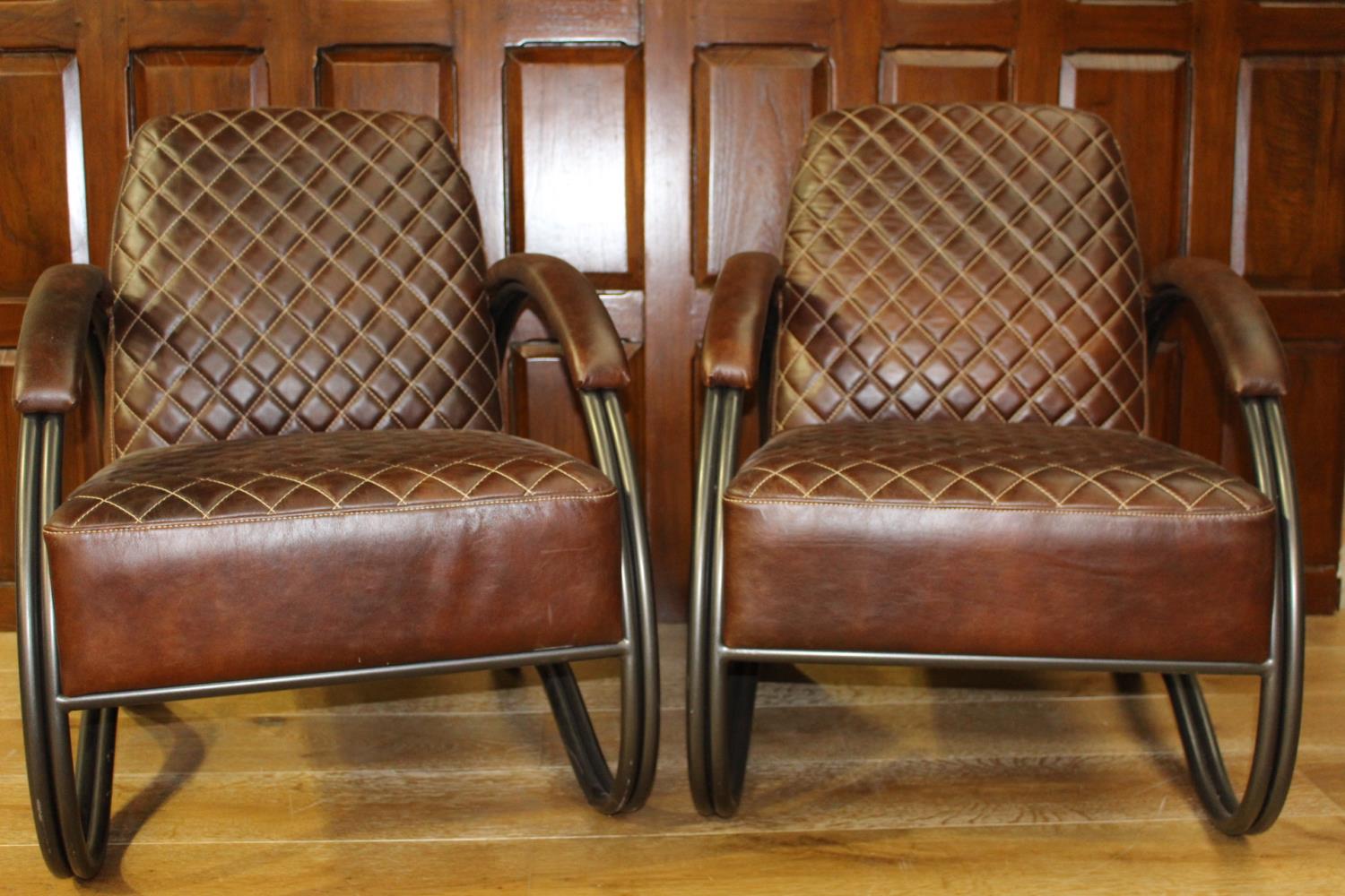 Pair of leather upholstered metal armchairs