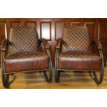 Pair of leather upholstered metal armchairs