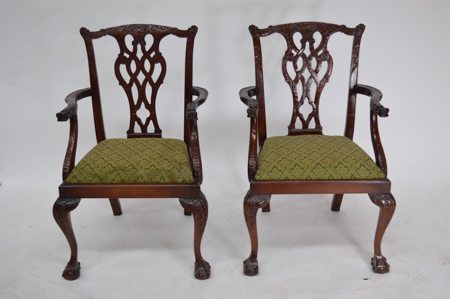 Pair of carved mahogany open arm chair.