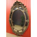 Carved giltwood oval wall mirror