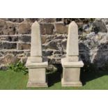 Pair of composition stone obelisks