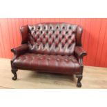 Leather Chesterfield wing backed settee.