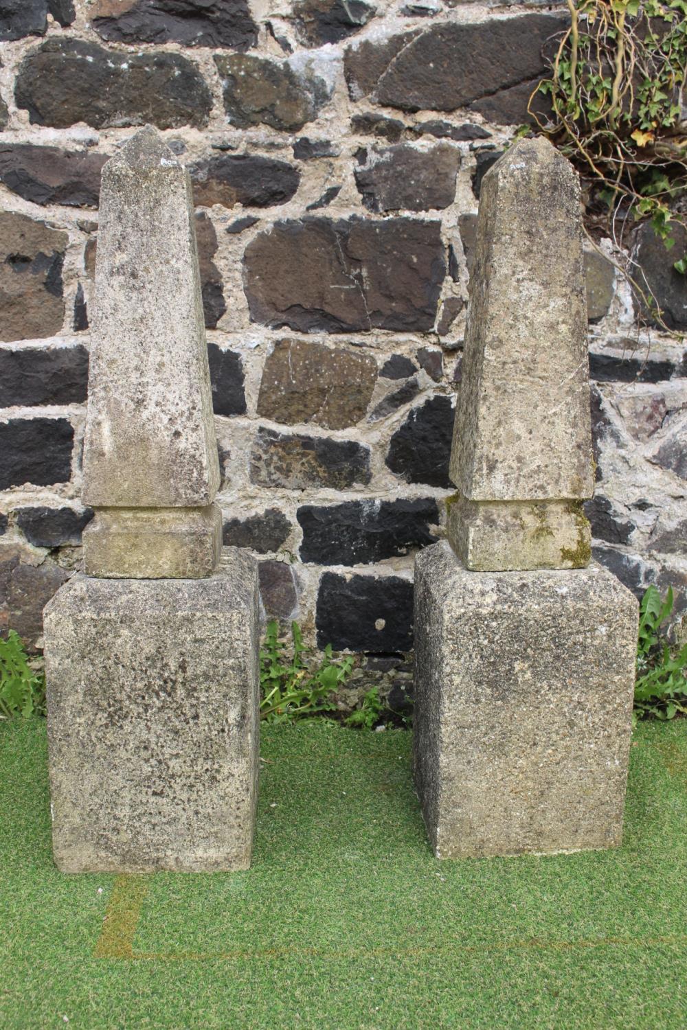 Pair of stone obelisks on base