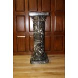Marble pedestal with Corinthian top.