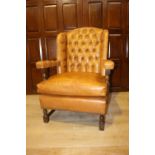 Leather wingback open armchair.