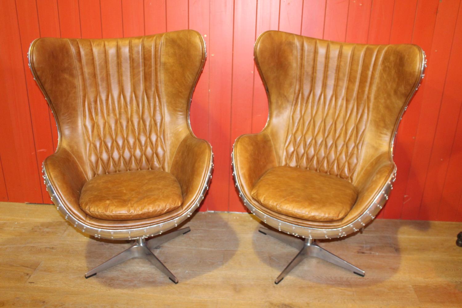 Pair of wingback aviator style swivel chairs