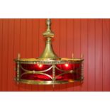 Circular brass and ruby glass hanging light