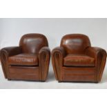 Pair of hand died leather club chairs.