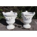 Pair of composition stone urns