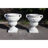Pair of composition stone urns