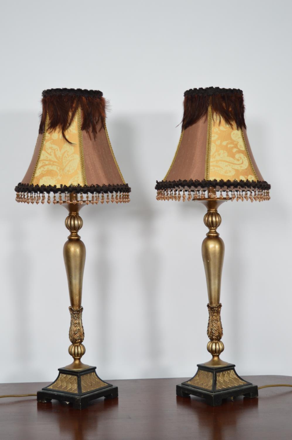 Pair of gilt table lamps with shades.