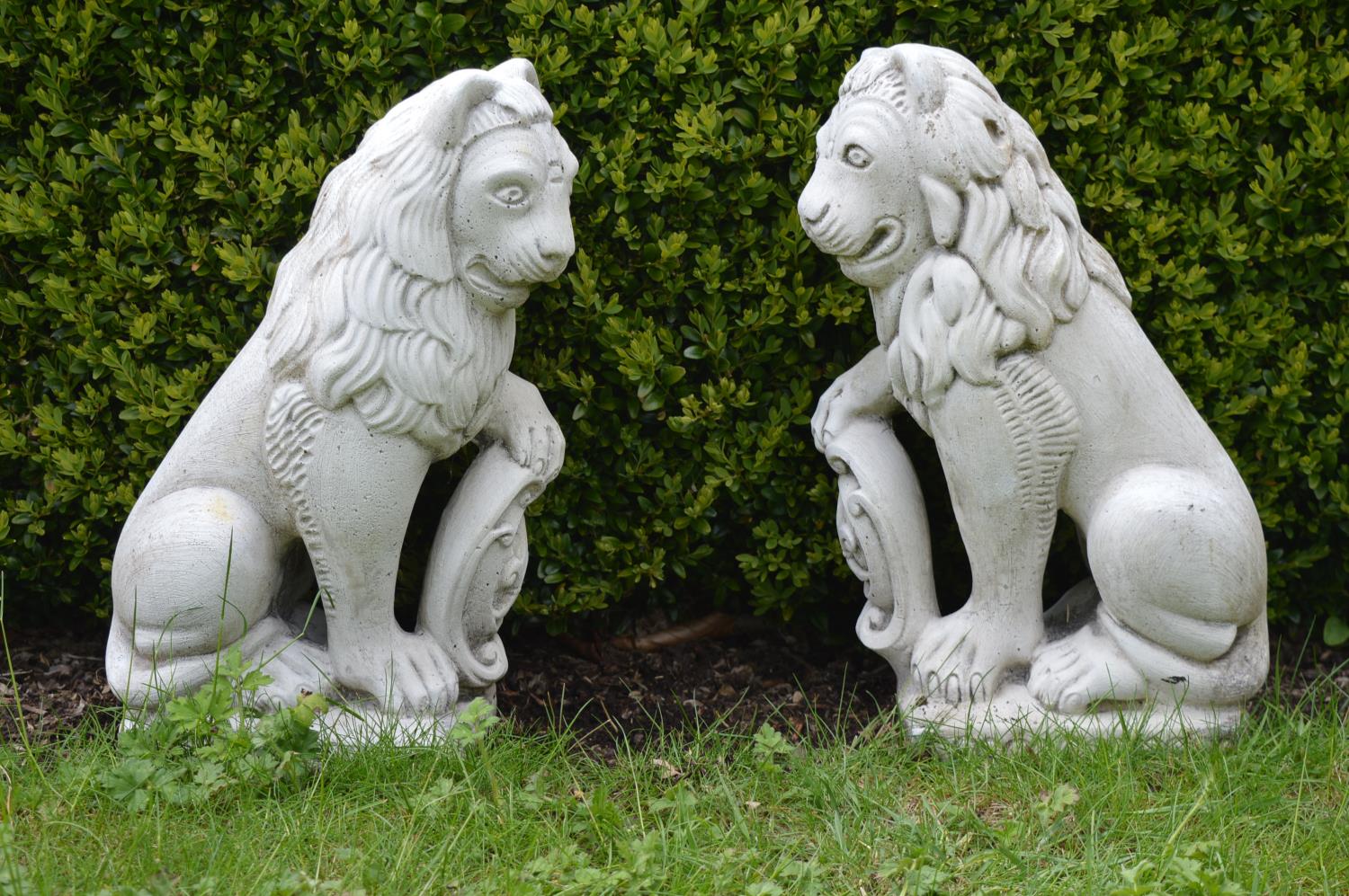 Pair of moulded stone seated lions