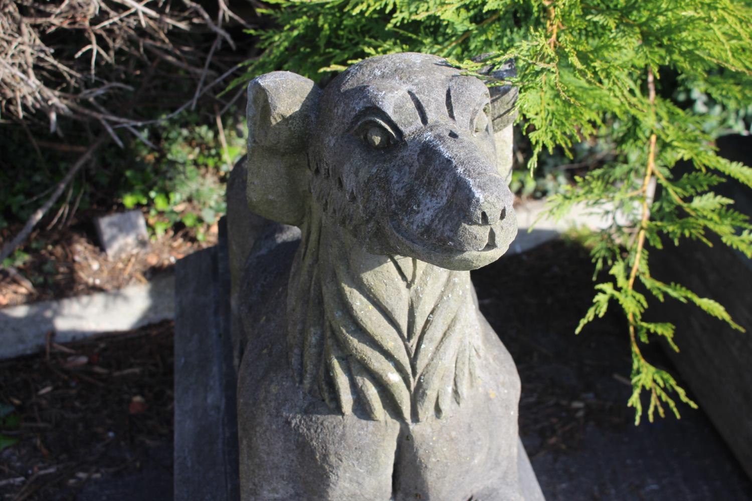 Pair of cast stone seated dogs