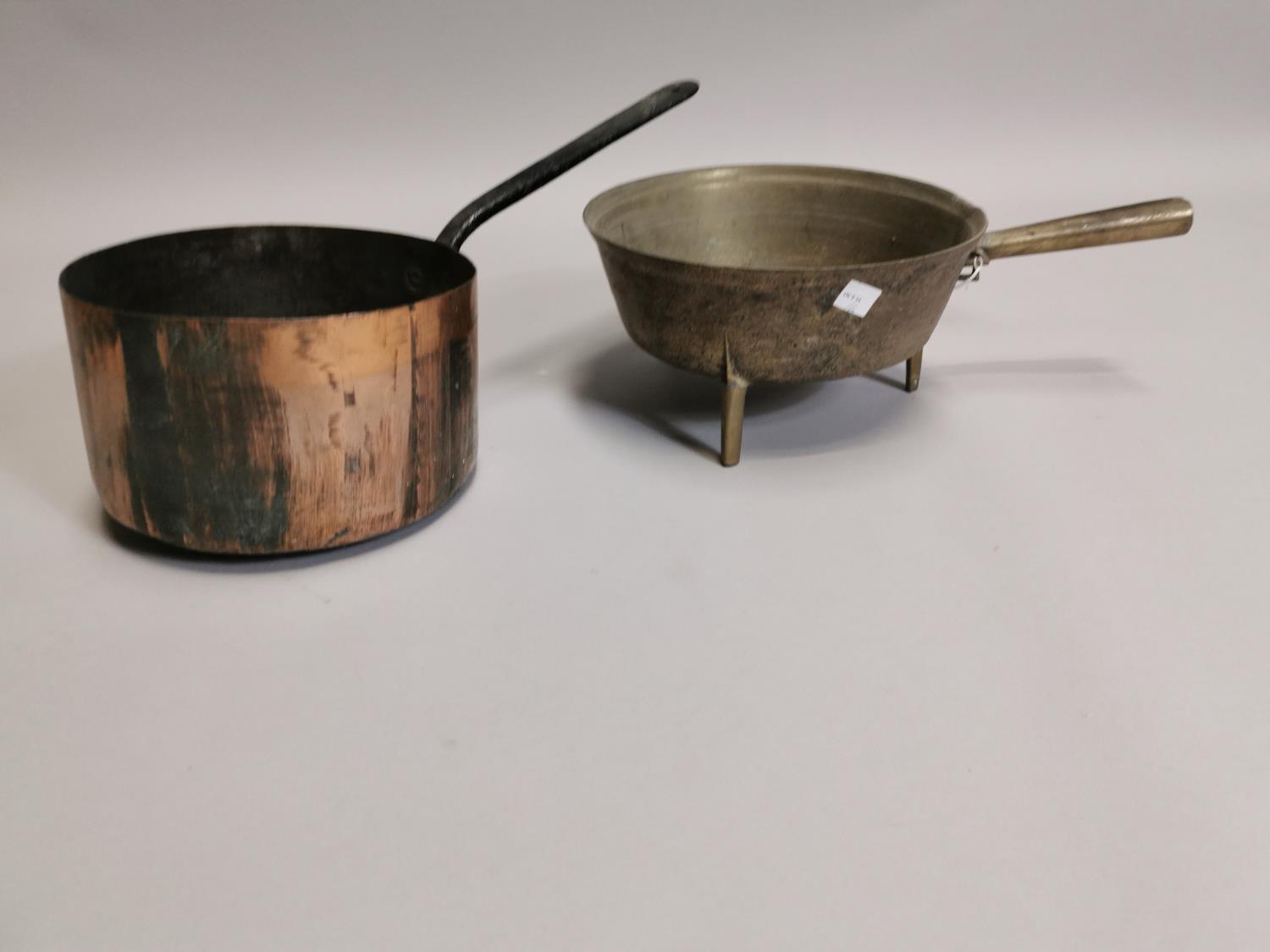 Two brass and copper saucepans.