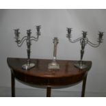 West & Son, Dublin, silver plated lamp base and a pair of candle sticks.