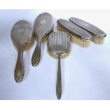 Four piece engine turned design silver dressing table set and another brush. Set – Birmingham 1925.