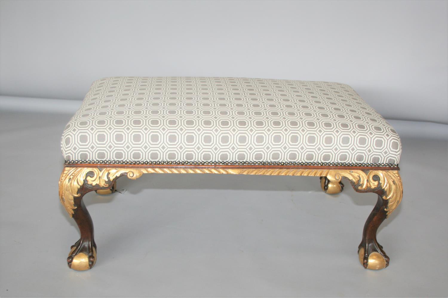 Decorative mahogany and gilt centre stool, upholstered with brass stud embellishment standing on