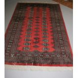 Persian design runner of rust coloured background. 210W x 130H