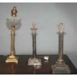 Two antique silver plated lamps of Corinthian column form and one brass Corinthian column form. 69H