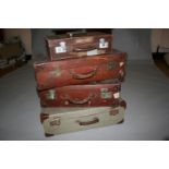 Four vintage leather suitcases, with compass, blade sharpener and wood plain.