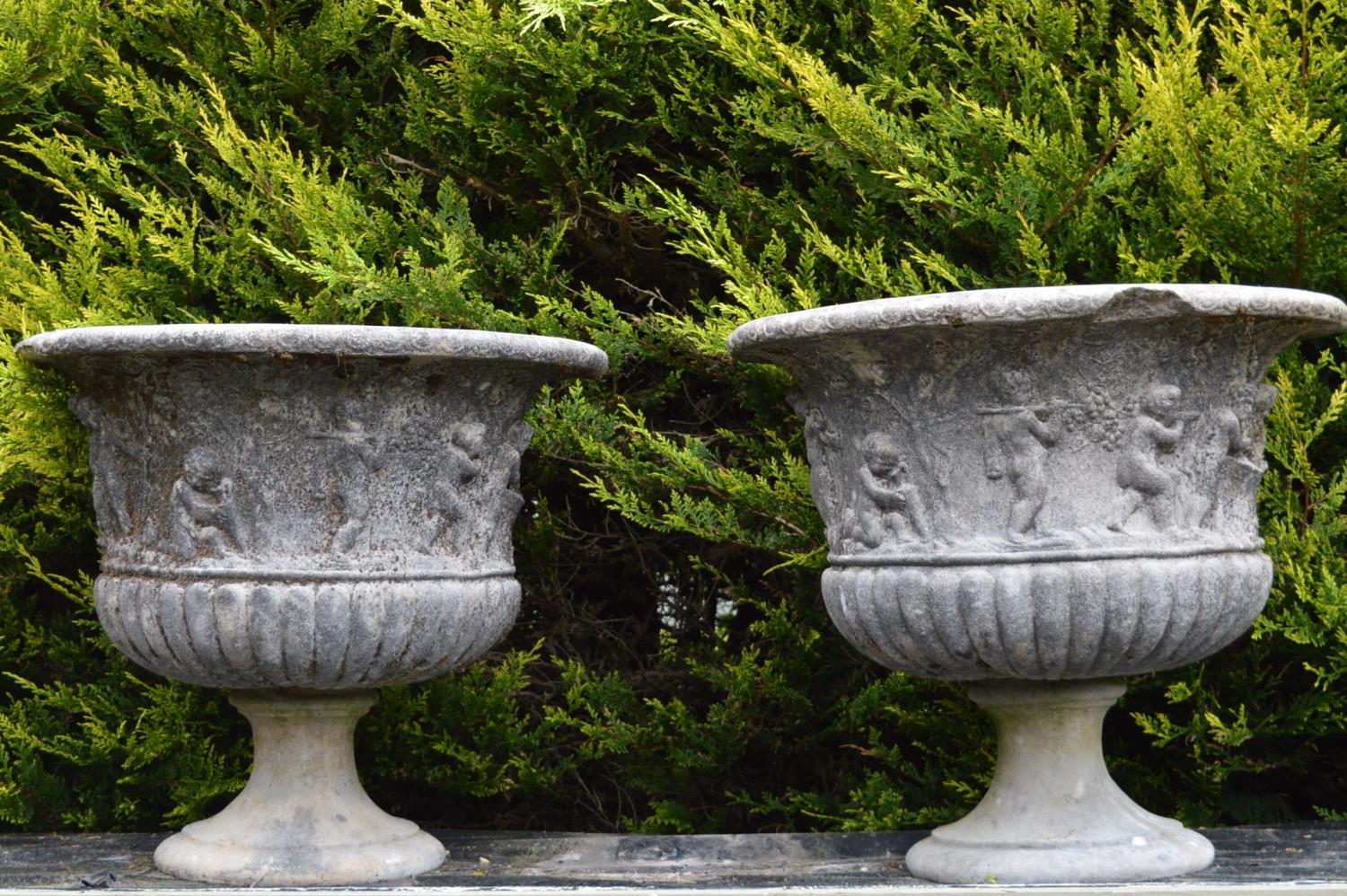 Pair of sandstone planters with figural decoration on circular bases 77W 69H