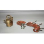 Set of four Georgian copper deal graduated plates, copper dust pan, brass watering can and