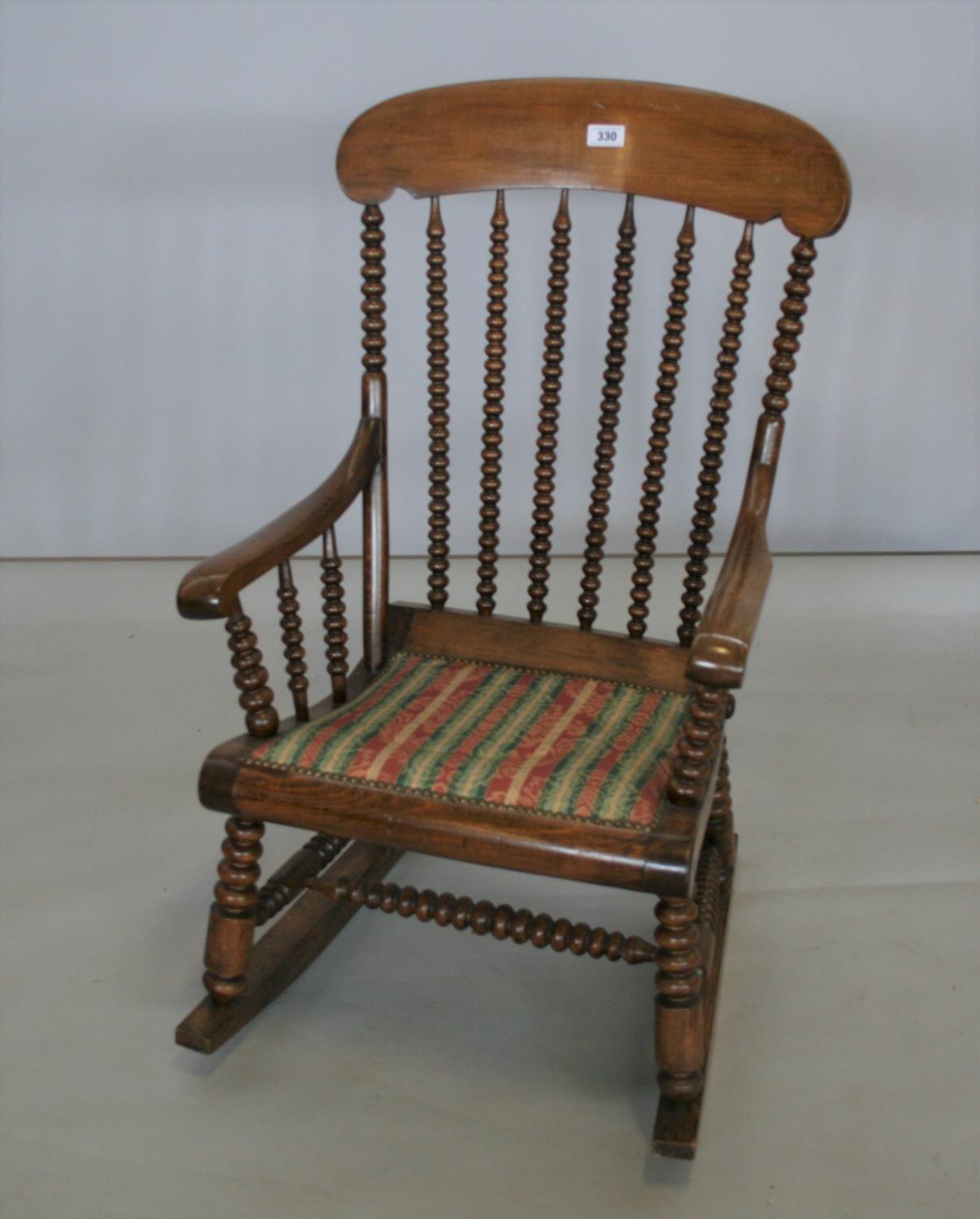 Unusual Edwardian bobbin design rocking chair. 60W x 106H x 65D