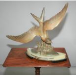 Art Deco bronzed flying bird surmounted on onyx and black marble base. 50W x 47H x 20D