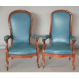Near pair of Edwardian mahogany armchairs, with speckled hide upholstery.