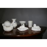 Seven pieces of Belleek including pair of seated dogs (with damage).