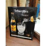 Schweppes tonic advertising sign.