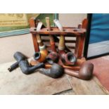 Vintage oak pipe stand and pipes.