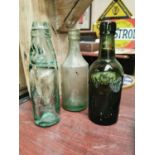 Three glass advertising bottles